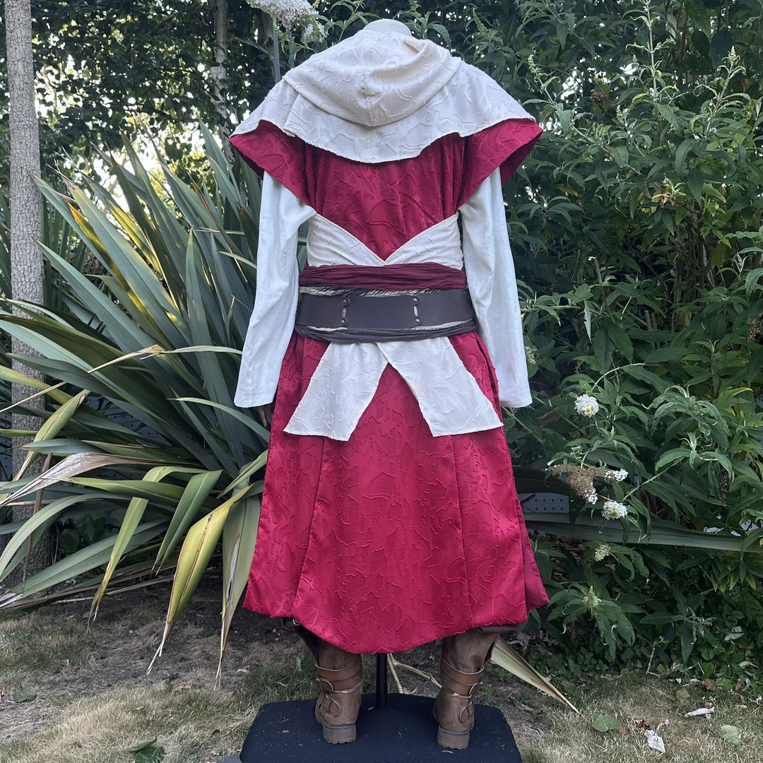 Cream hood and waistcoat over red, hood up with the ends draped as a cape, back view. Belt sold separately.