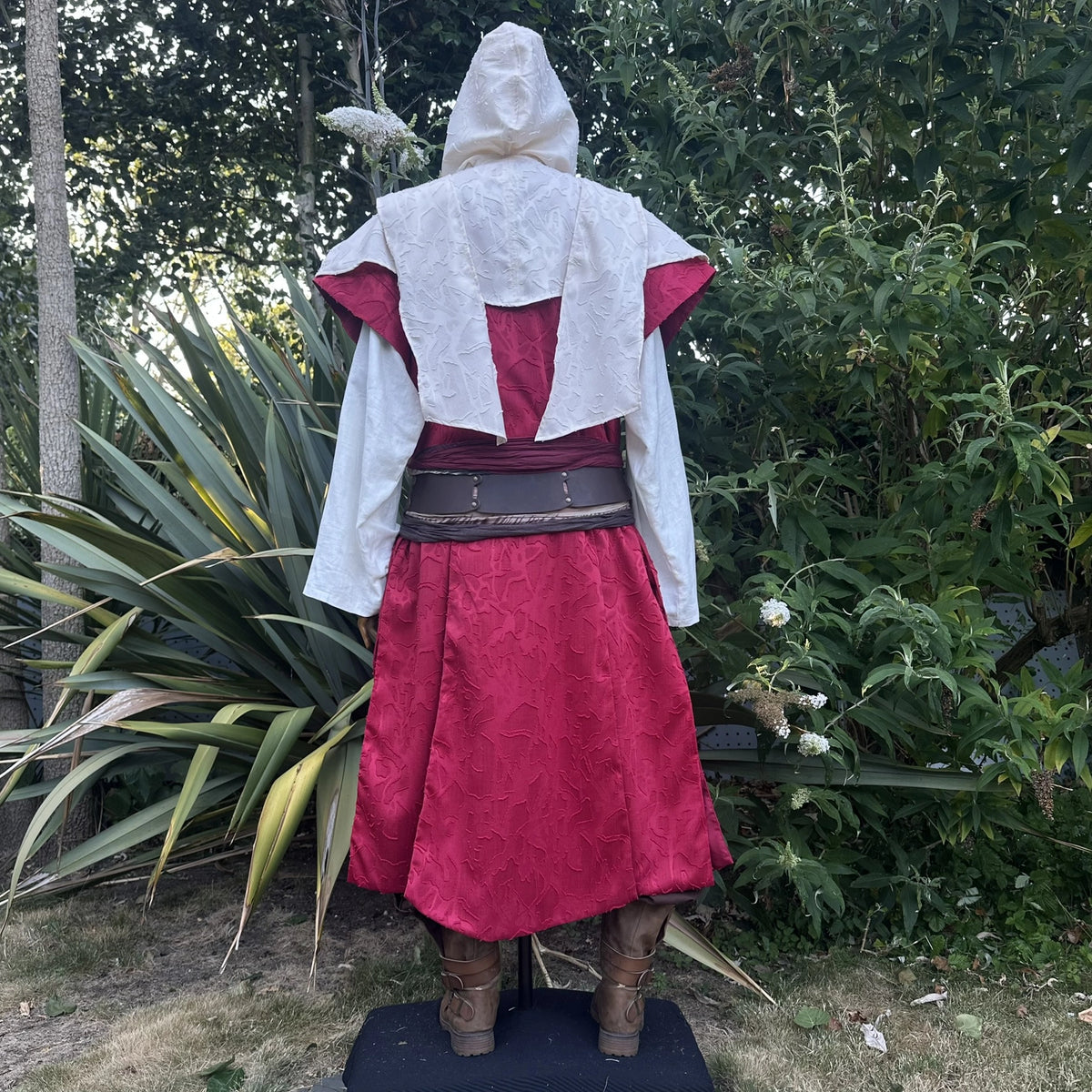 Cream hood and waistcoat over red, hood up, back view.