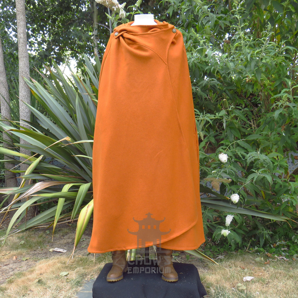 Rust wool cloak fastened closed with the hood gathered down at the neck