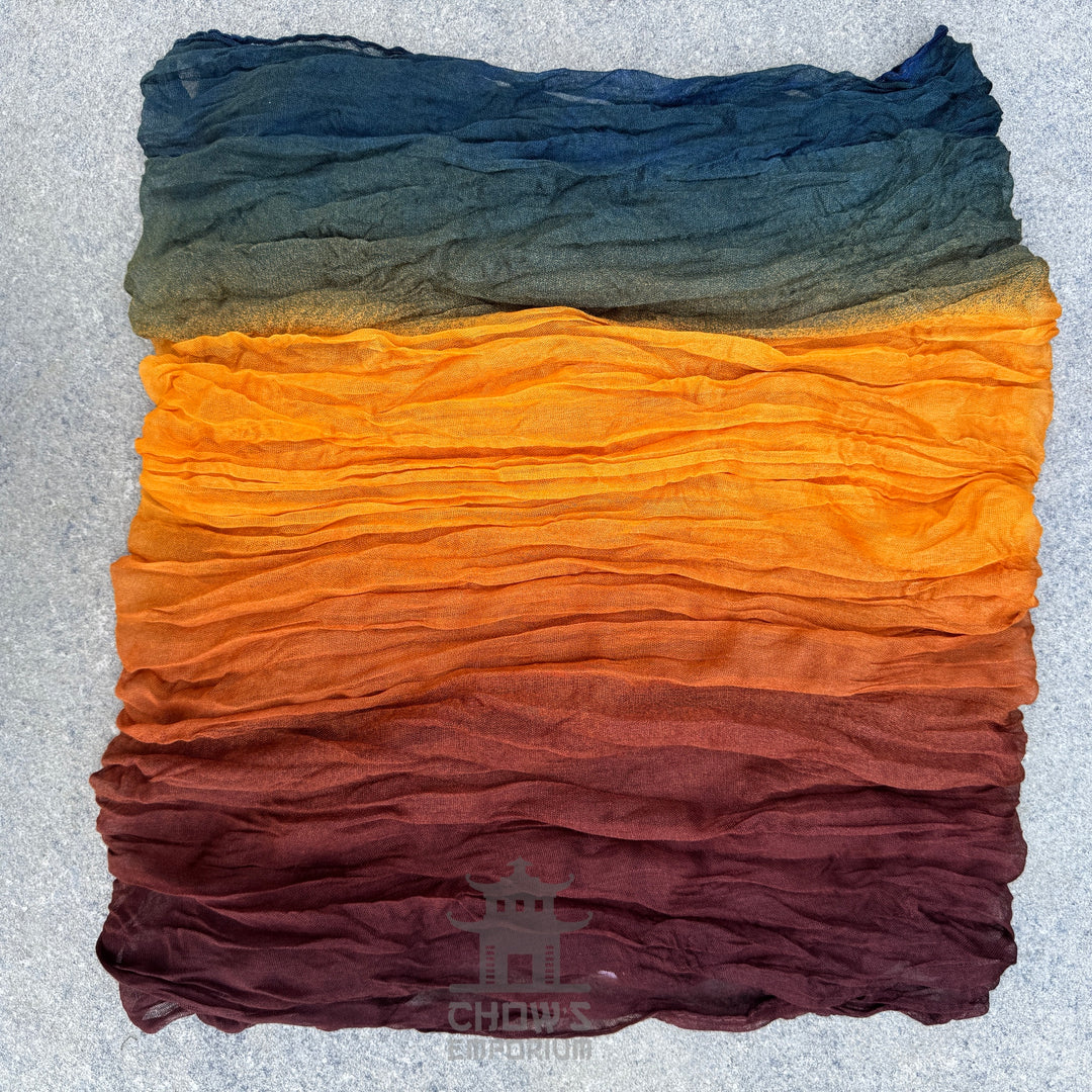 Folded Spice pirate sash showing warm autumn gradient with teal band