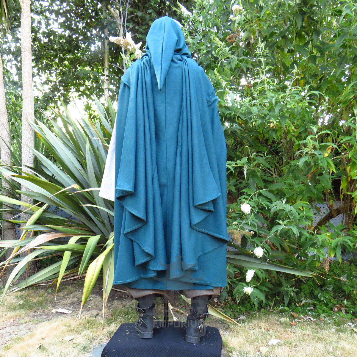 Back view of the teal cloak with the hood raised and the full length falling behind