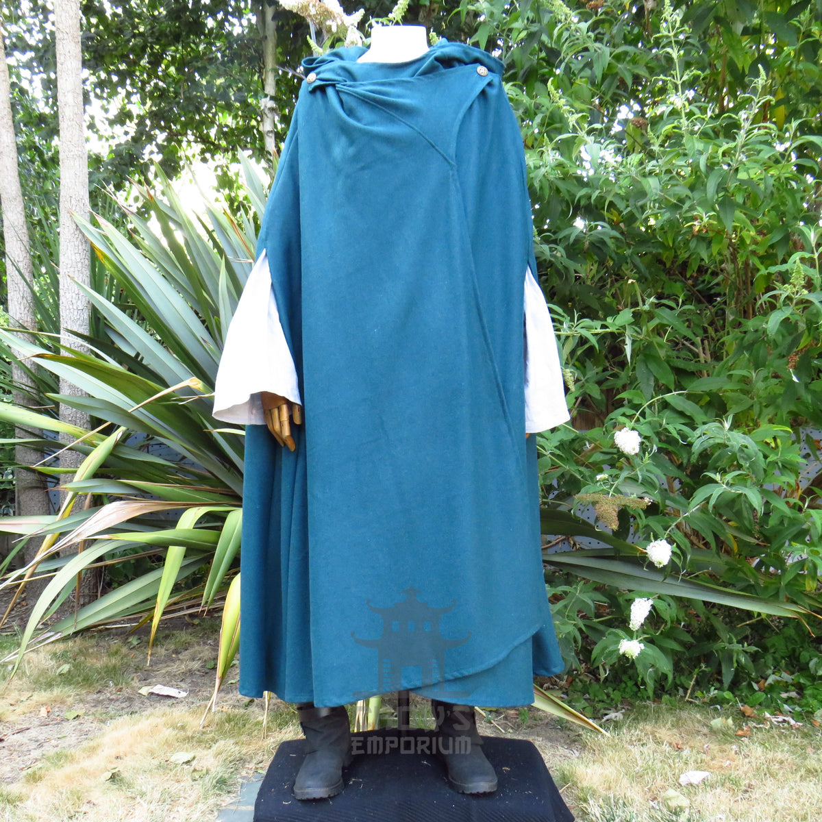 Teal hooded cloak worn open over a white tunic, tunic sold separately