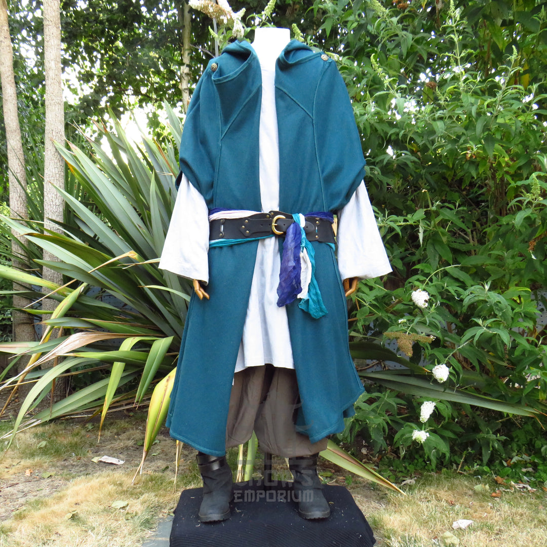 Teal hooded cloak styled open over a tunic with a sash at the waist, other pieces sold separately