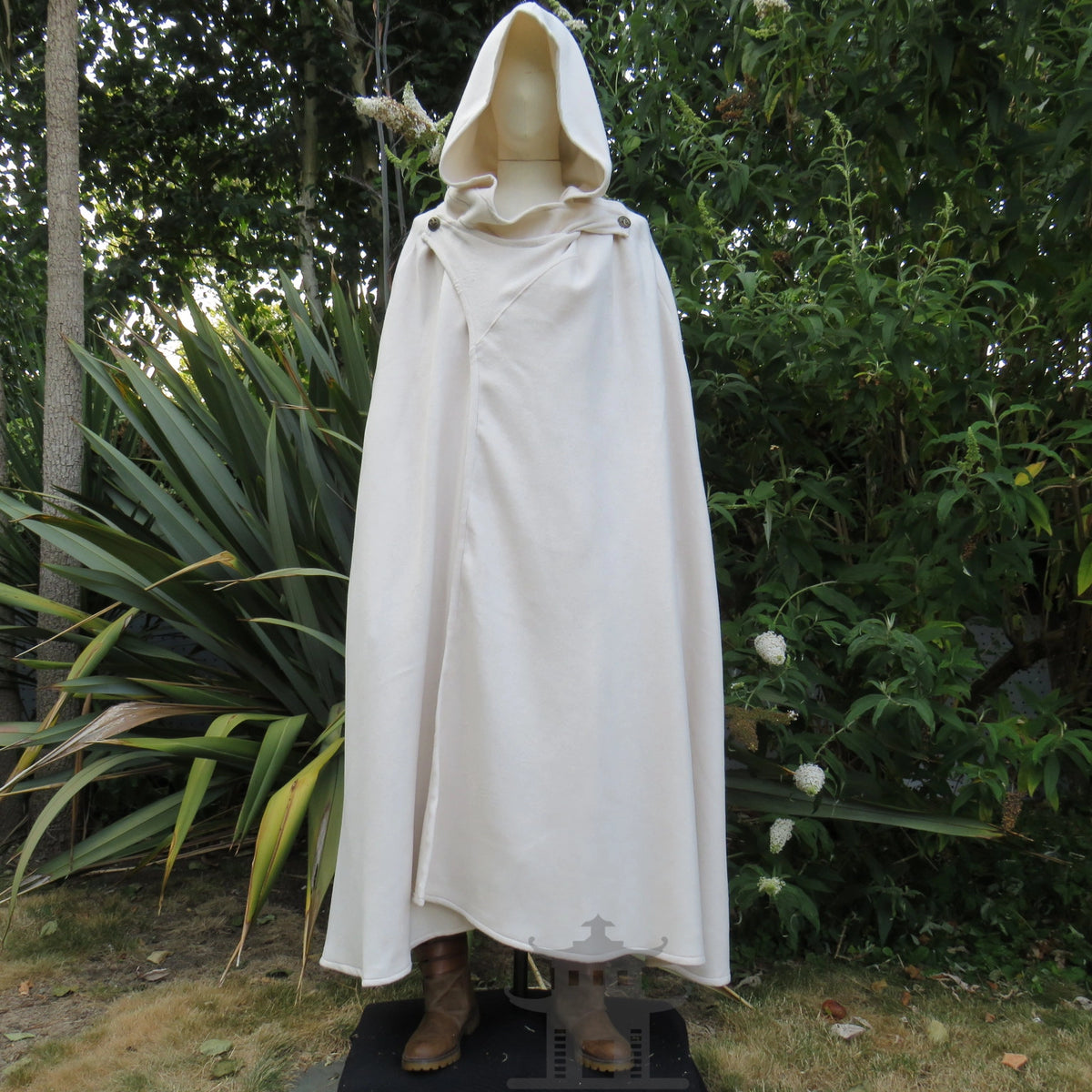 White cloak fastened double-breasted across the chest with the hood raised