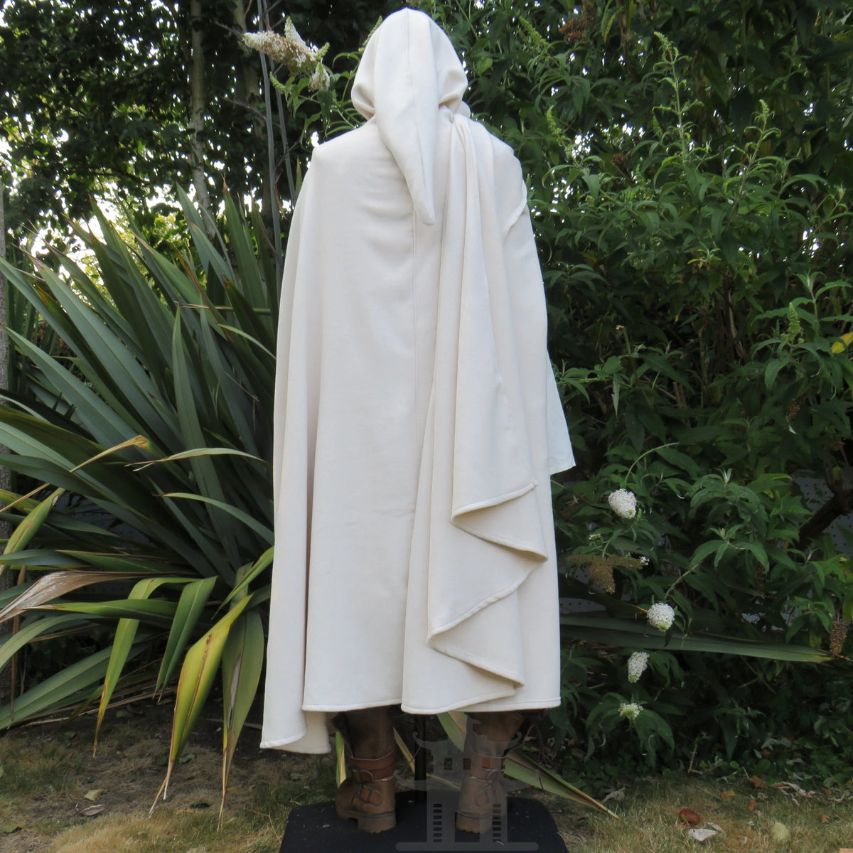 Three-quarter back view of the white cloak showing the hood and rear drape