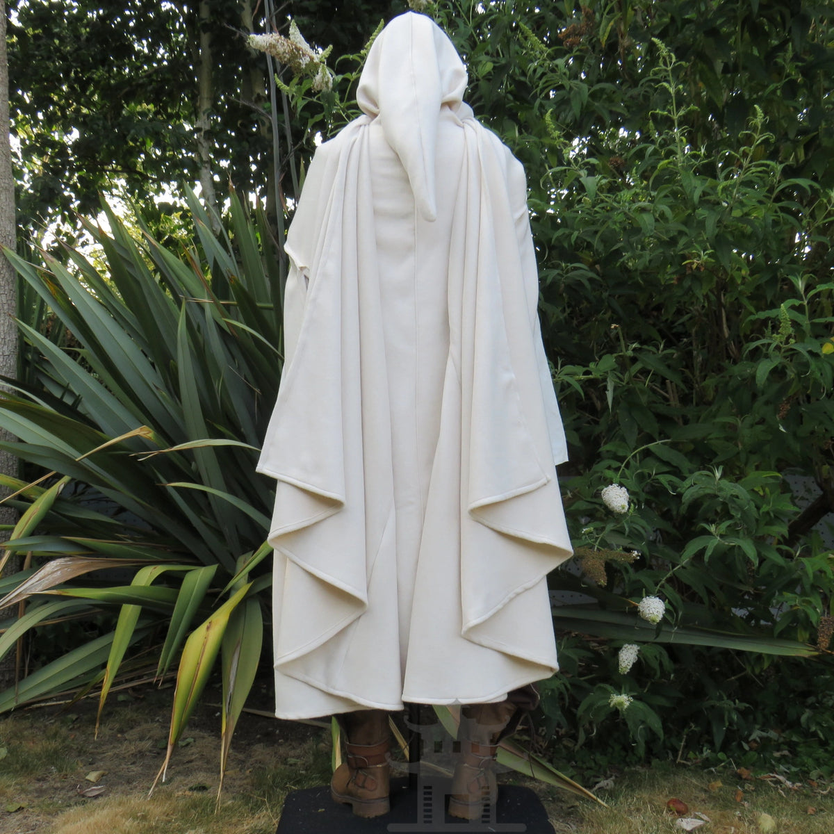 Back view of the white hooded cloak showing the full sweep of the hem