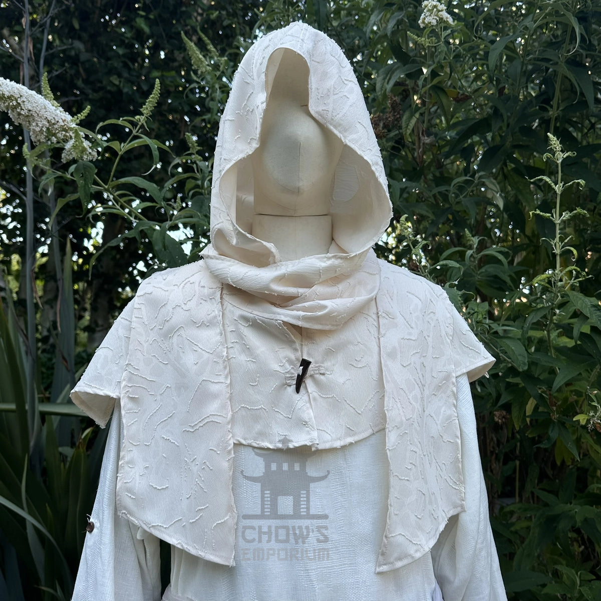 White medieval scarf hood worn up over the head, wraparound ends draped