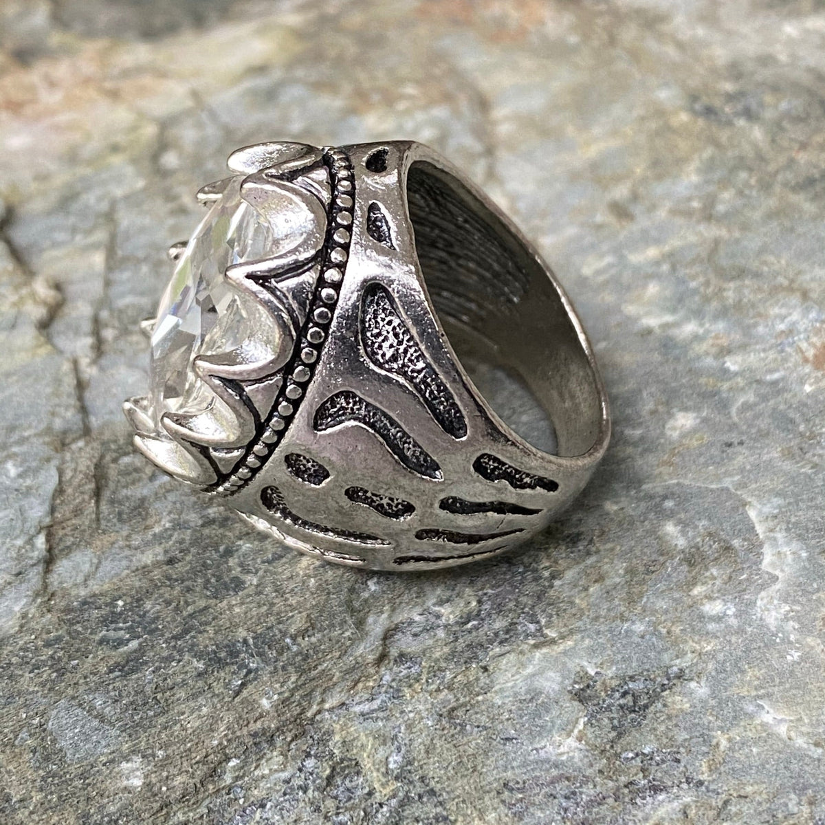 Ornate silver ring with white stone, side view for medieval LARP.