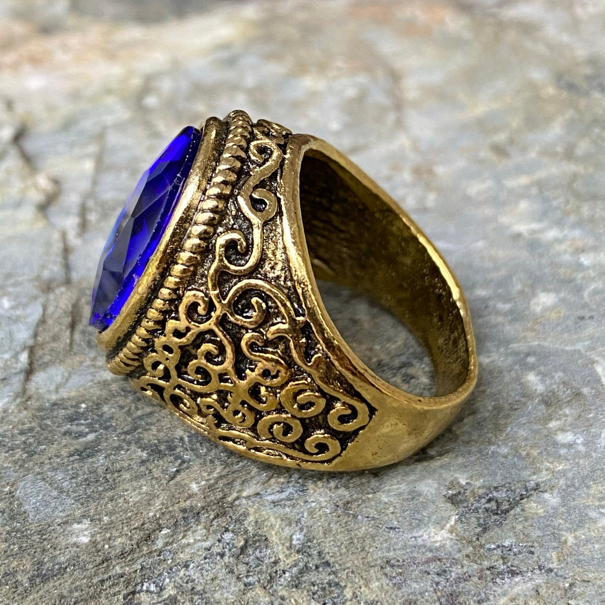 Antique-style gold ring with blue gem, ornate swirling design for LARP.