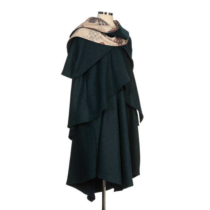 This Layered Woollen LARP Cloak in Teal has multiple tiers of folded fabric to keep you warm and enhance your kit. The Viking Cloak has a Hood attached that, along with the LARP Cloak, keep you warm and dry. The Medieval Cape has an Elaborate Lining to add flare to your LARP Character, Cosplay Event, or Ren Faire. 