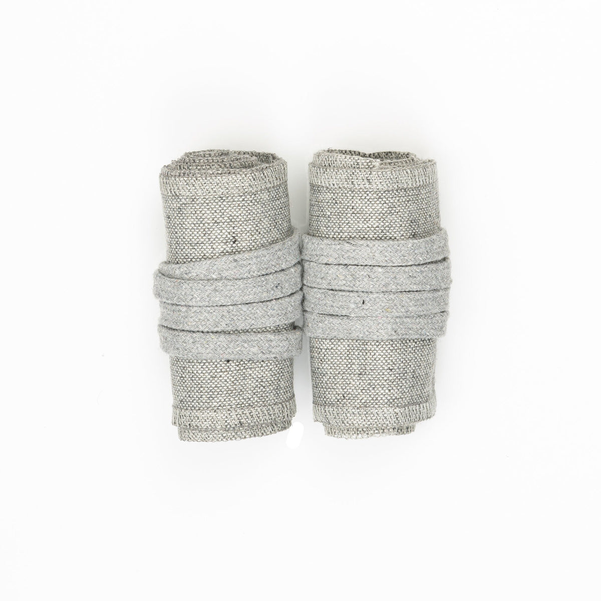 Light grey wool arm wraps rolled, top view for LARP or medieval attire.