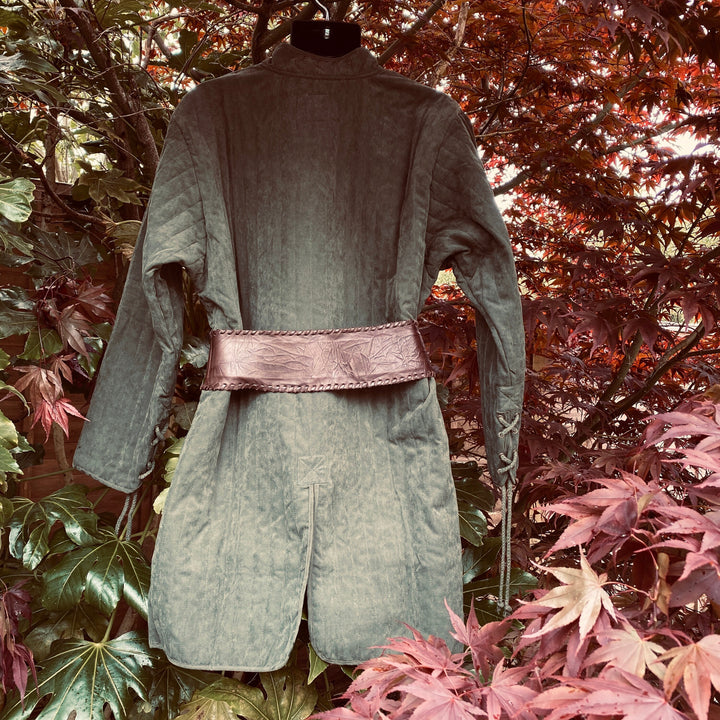 This Thin LARP Gambeson comes in Green Cotton. This Padded Tunic can sit on top of the rest of your kit. This Lightweight Gambeson is water resistant and keeps you warm. This Viking Tunic is perfect for your LARP Costume and LARP Character, Cosplay Events, and Ren Faires.