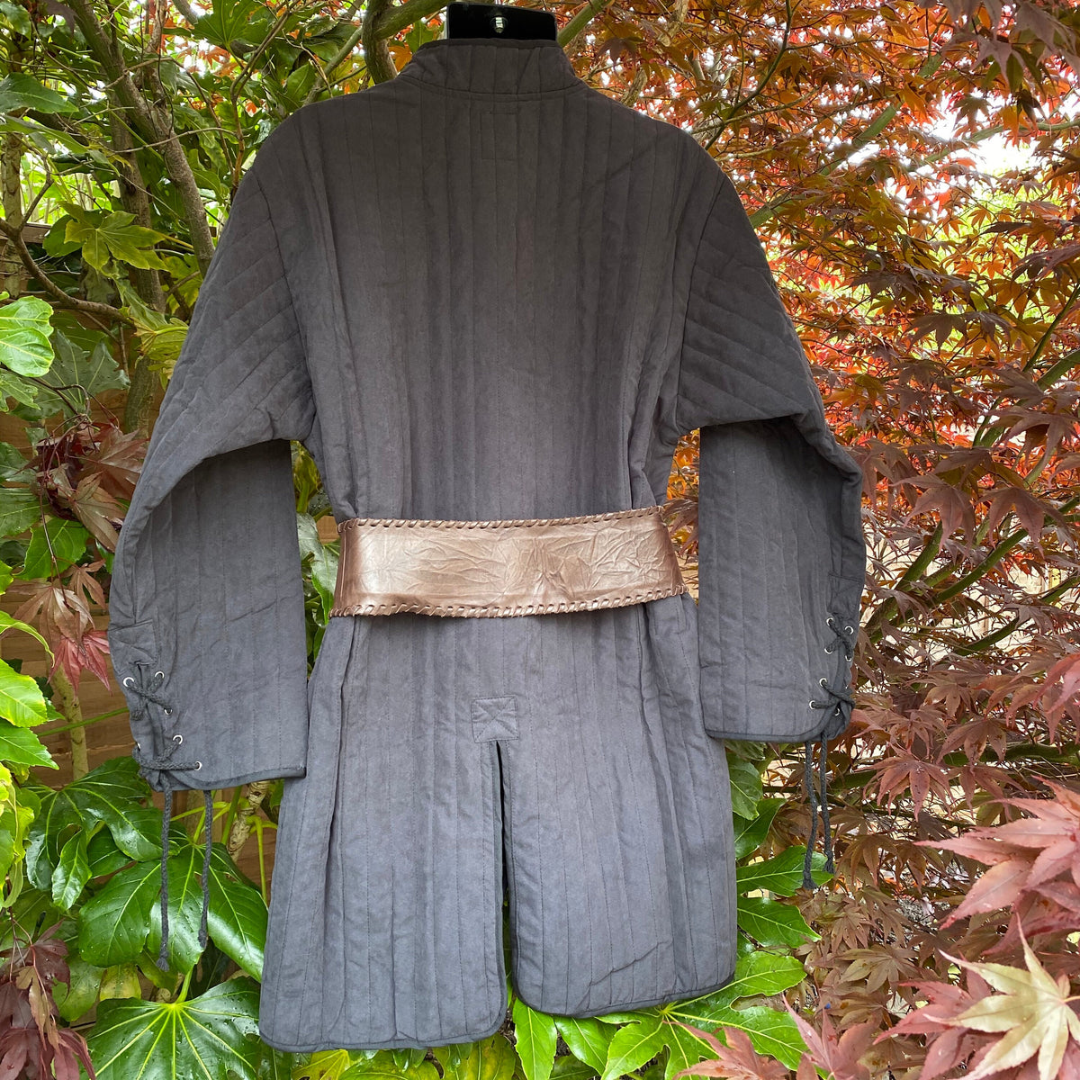 Back view of black LARP gambeson with stitched leather belt detail.