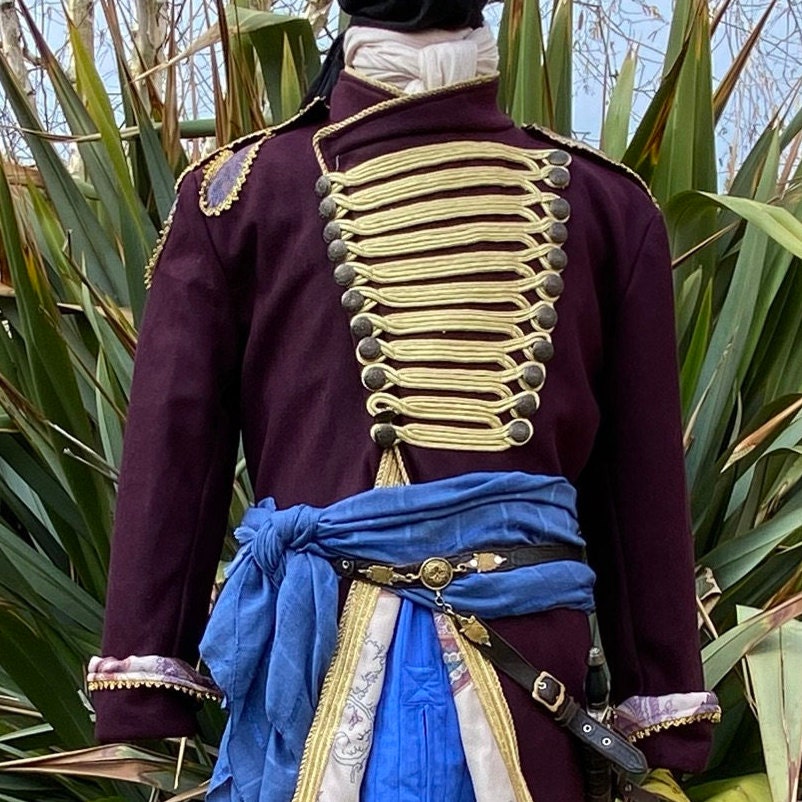 Rear view of LARP pirate coat with gold braid and blue sash detail.
