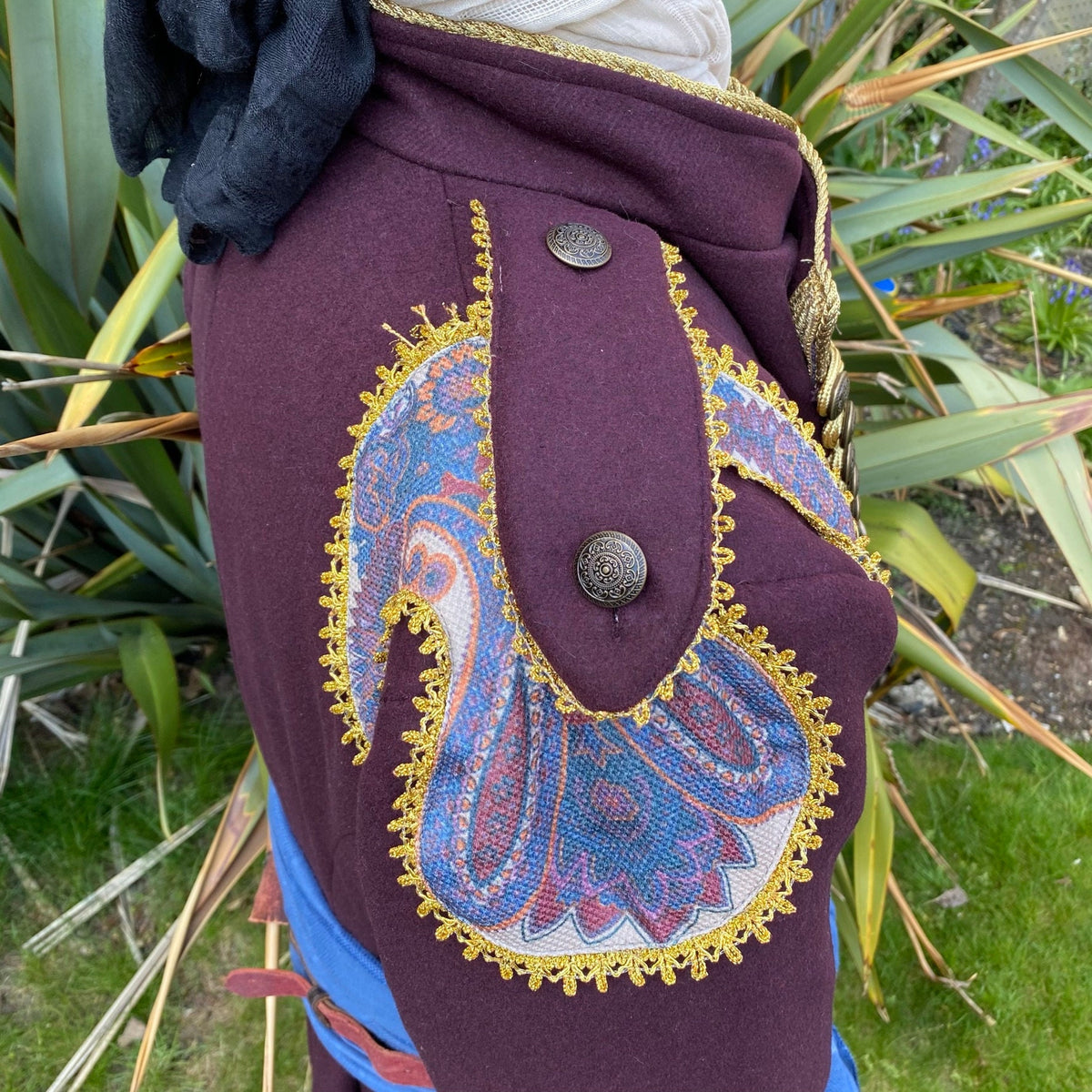 Maroon coat with paisley trim detail, side view, for LARP costume.