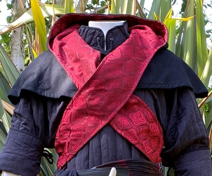 This LARP Hood is Black with a Wrap Around extention. This Viking Scarf Hood is made of Faux Suede Effect, and is Water Resistant and Warm. It has an interior Elaborate Red Satin Pattern, perfect for your LARP Character and LARP Costume, Cosplay Event, and Ren Faire.