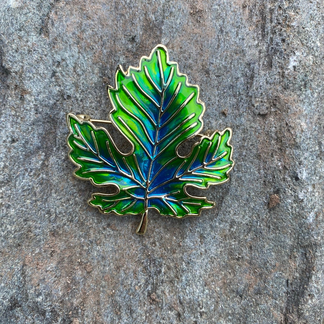 Gold-edged green leaf pin on stone for LARP.