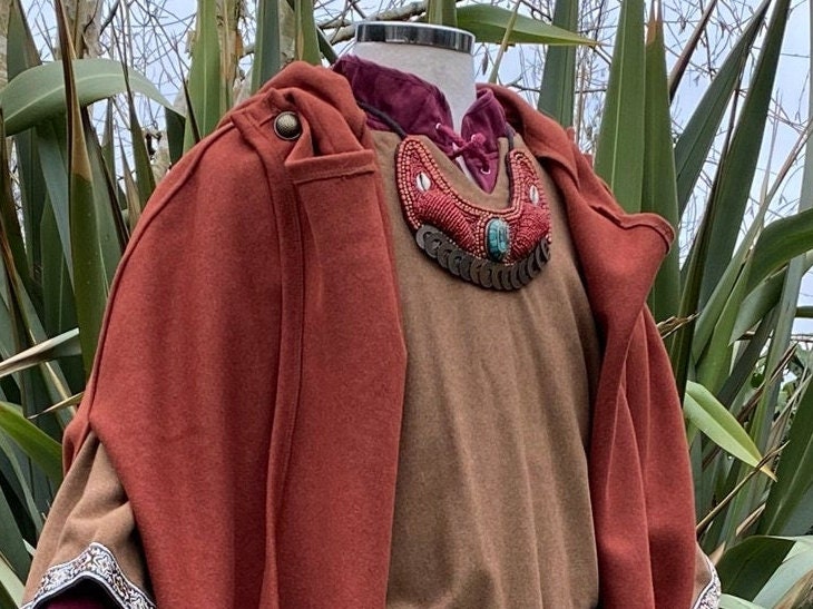 Mannequin wears Maasai bead necklace with medieval cloak for LARP.