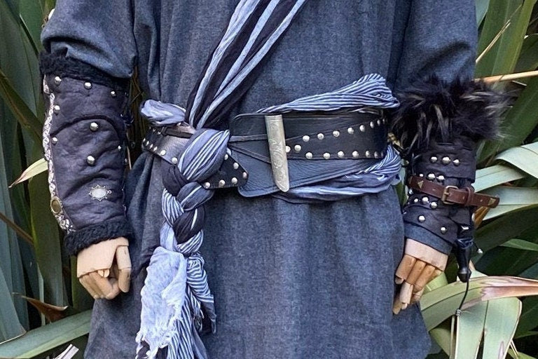 LARP black faux vambraces with studs and fur, paired with a blue tunic.