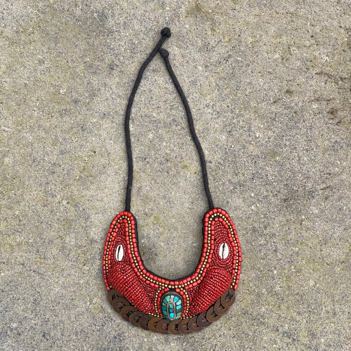 Horseshoe-shaped Maasai necklace on stone for LARP.