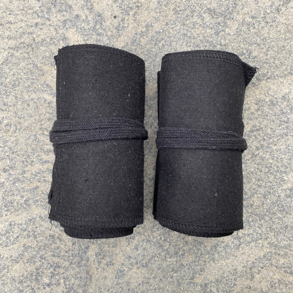 Set of Medieval LARPing Leg Wraps. They are Black and made out of a Wool mixture which are used to keep Trouser flares out of the way and legs warm. These Viking Wraps can wrap around your Legs to provide an extra flare to LARP kit.
