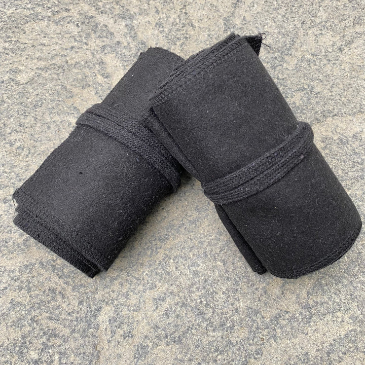 Set of Medieval LARPing Leg Wraps. They are Black and made out of a Wool mixture which are used to keep Trouser flares out of the way and legs warm. These Viking Wraps can wrap around your Legs to provide an extra flare to LARP kit.