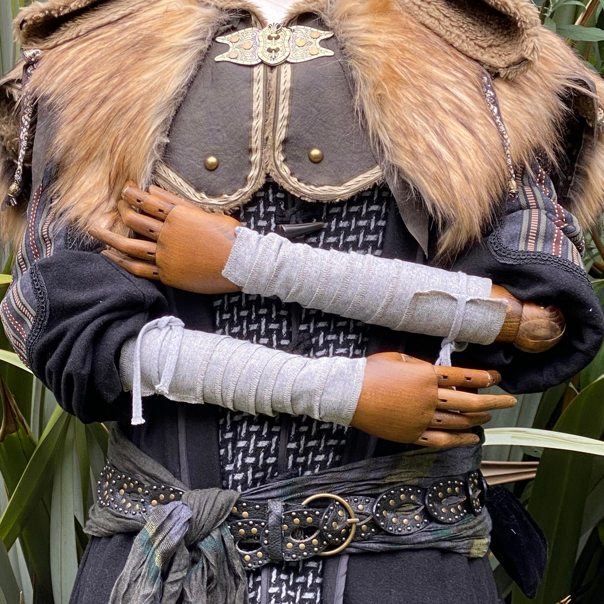 Light grey wool arm wraps on medieval outfit with fur and leather details for LARP.