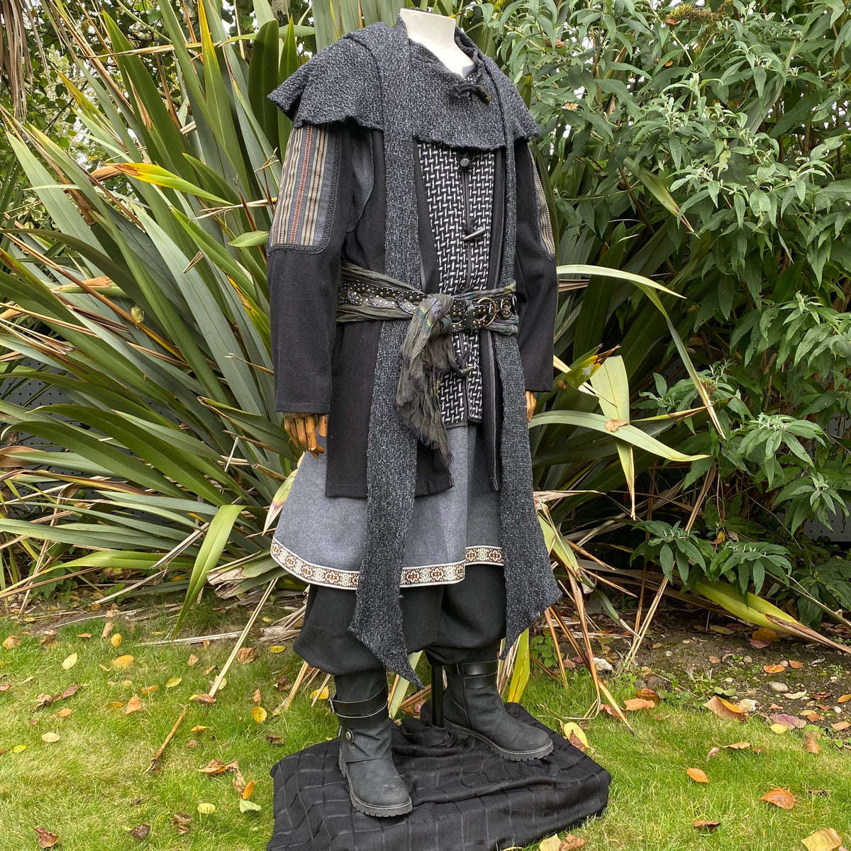 Medieval LARP outfit on mannequin, detailed layered jacket, side view.