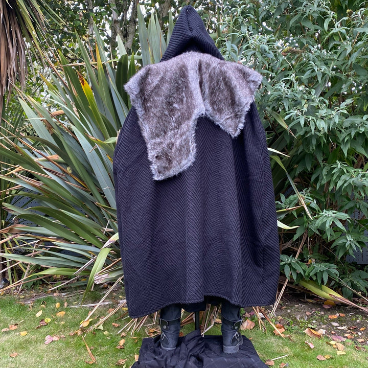 The Four Way LARP Cloak in Black Herringbone Wool with Reversable Grey Faux Fur & Leather Brown Mantle is a Versatile Cape with Hood. The Medieval Cloak is Water Resistant and helps keep you warm. The Viking Style Cloak can be worn in four ways; perfect for your LARP character, Cosplay Events, and Ren Faires. 