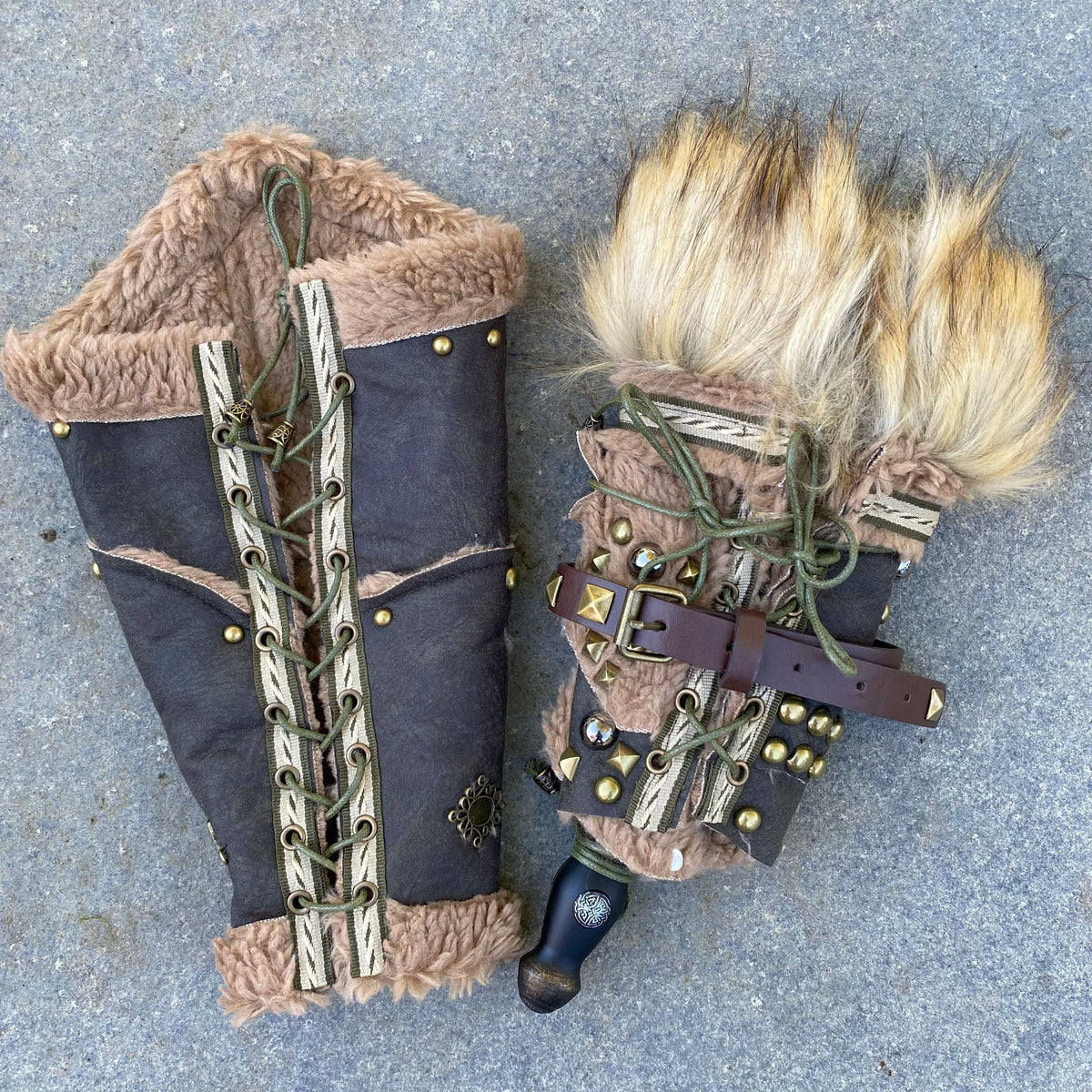 Medieval LARP vambraces with fur trim, green lacing, and buckle detail.
