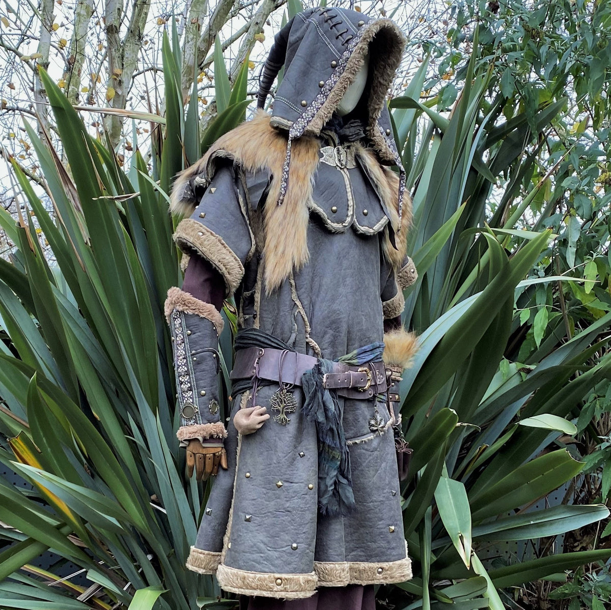 Mannequin in medieval LARP set showing fur-lined hood and vambraces.