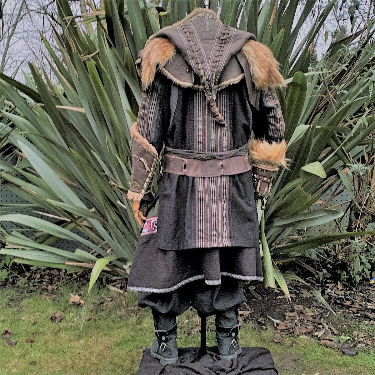 Back view of medieval LARP outfit with fur trim and leather hood.