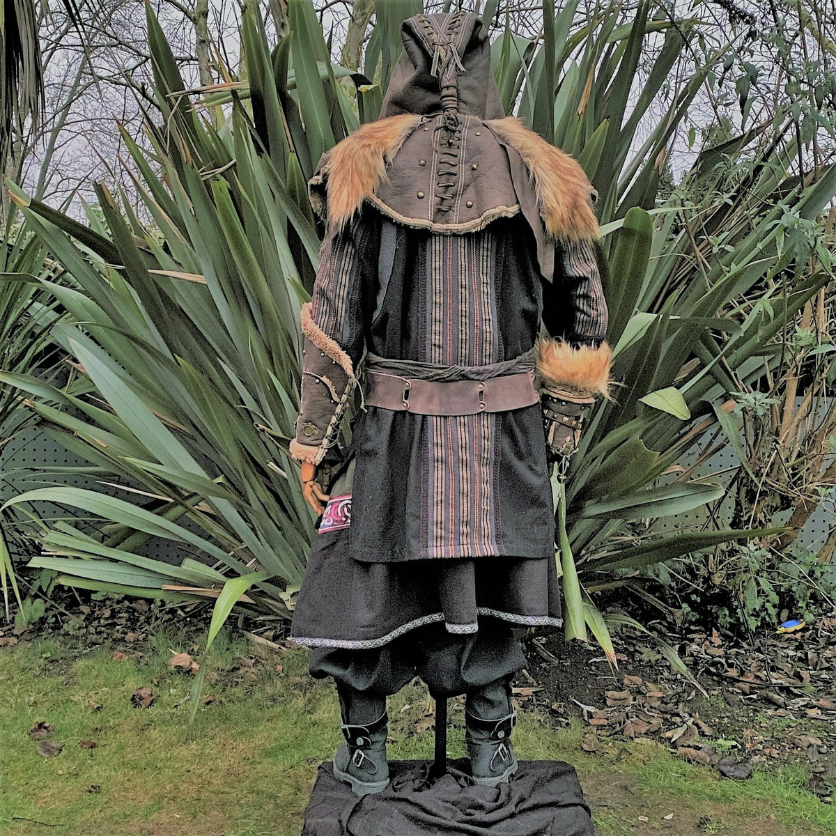Back view of medieval LARP outfit with fur-trimmed hood and leather accents.