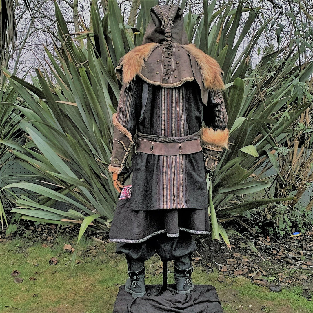 Back view of medieval LARP outfit with fur-trimmed hood and leather accents.