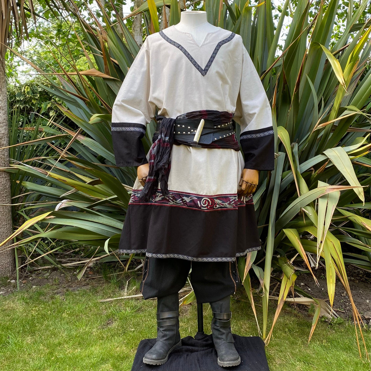 Medieval LARP attire; front view with embroidered tunic and dark trousers.