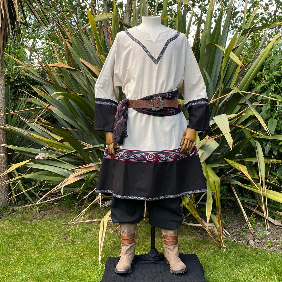 Medieval LARP attire with detailed belt and boots on.