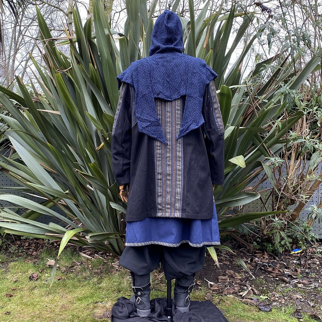 Blue hooded LARP coat with striped back panel and black trousers, rear view.
