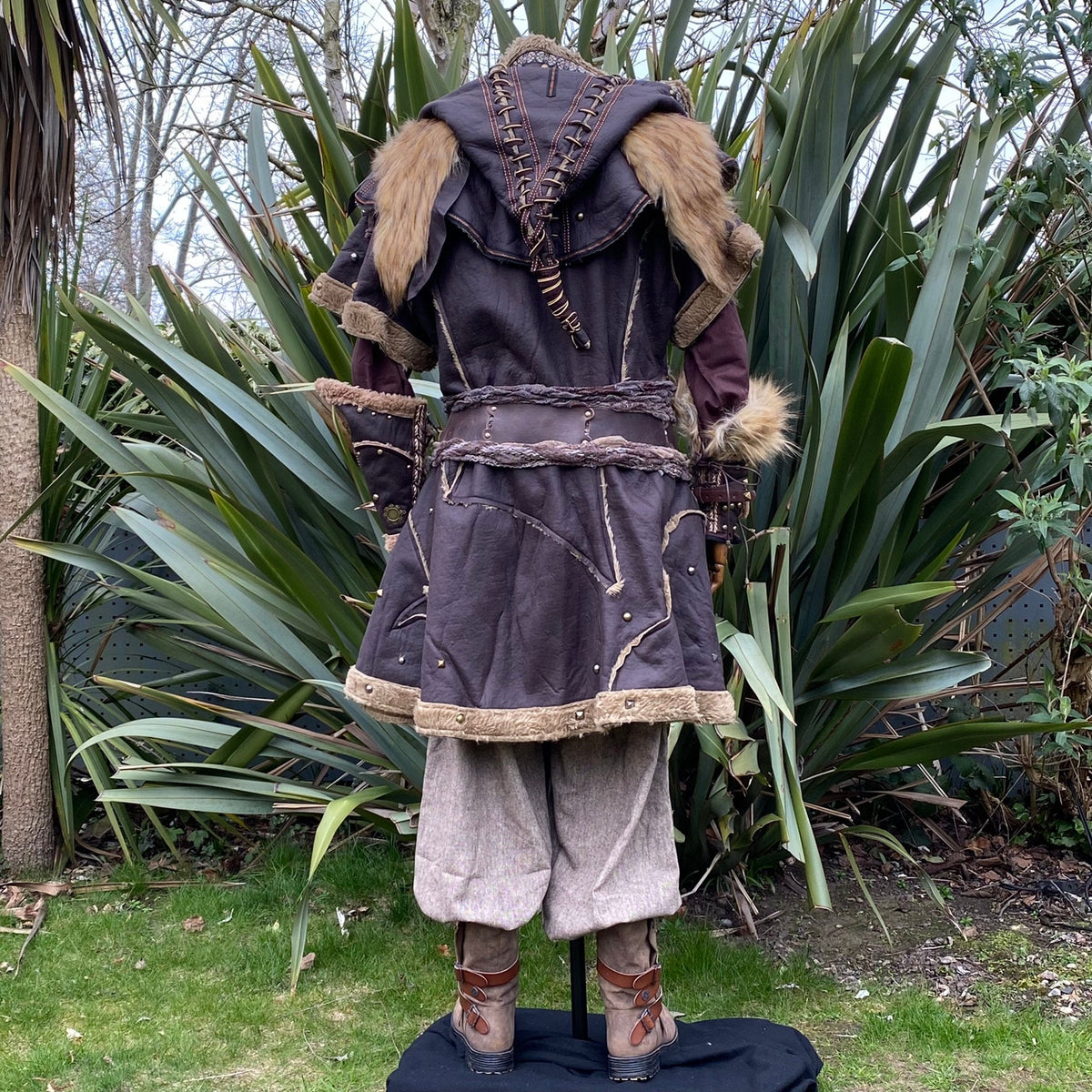 Back view of medieval LARP outfit; ornate hood, fur details, and layered textures.