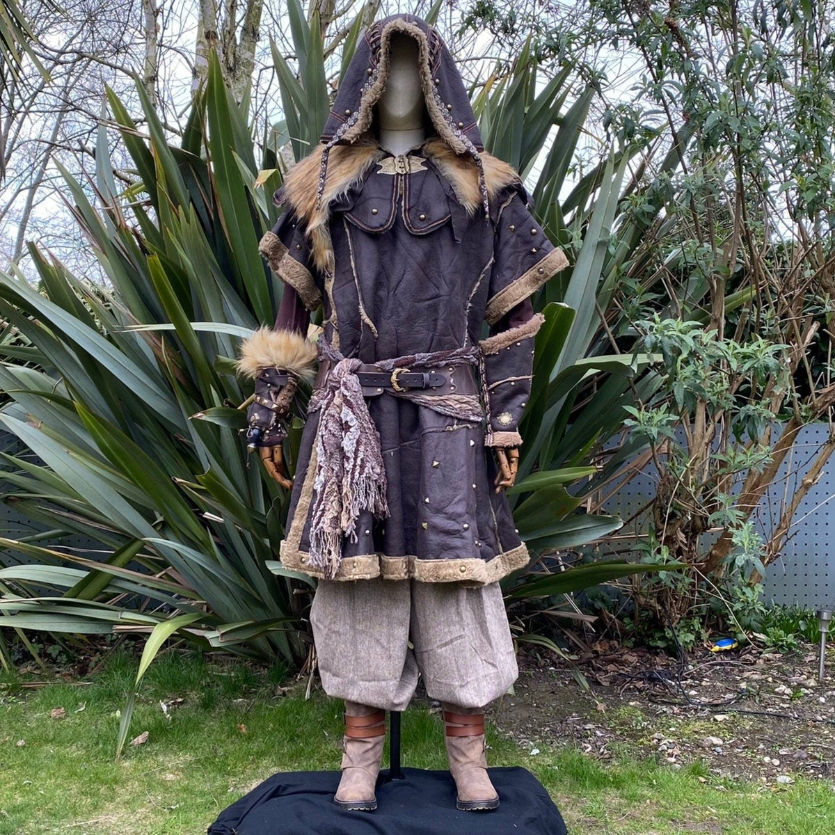 Medieval LARP outfit on mannequin, fur hood and ornate tunic.