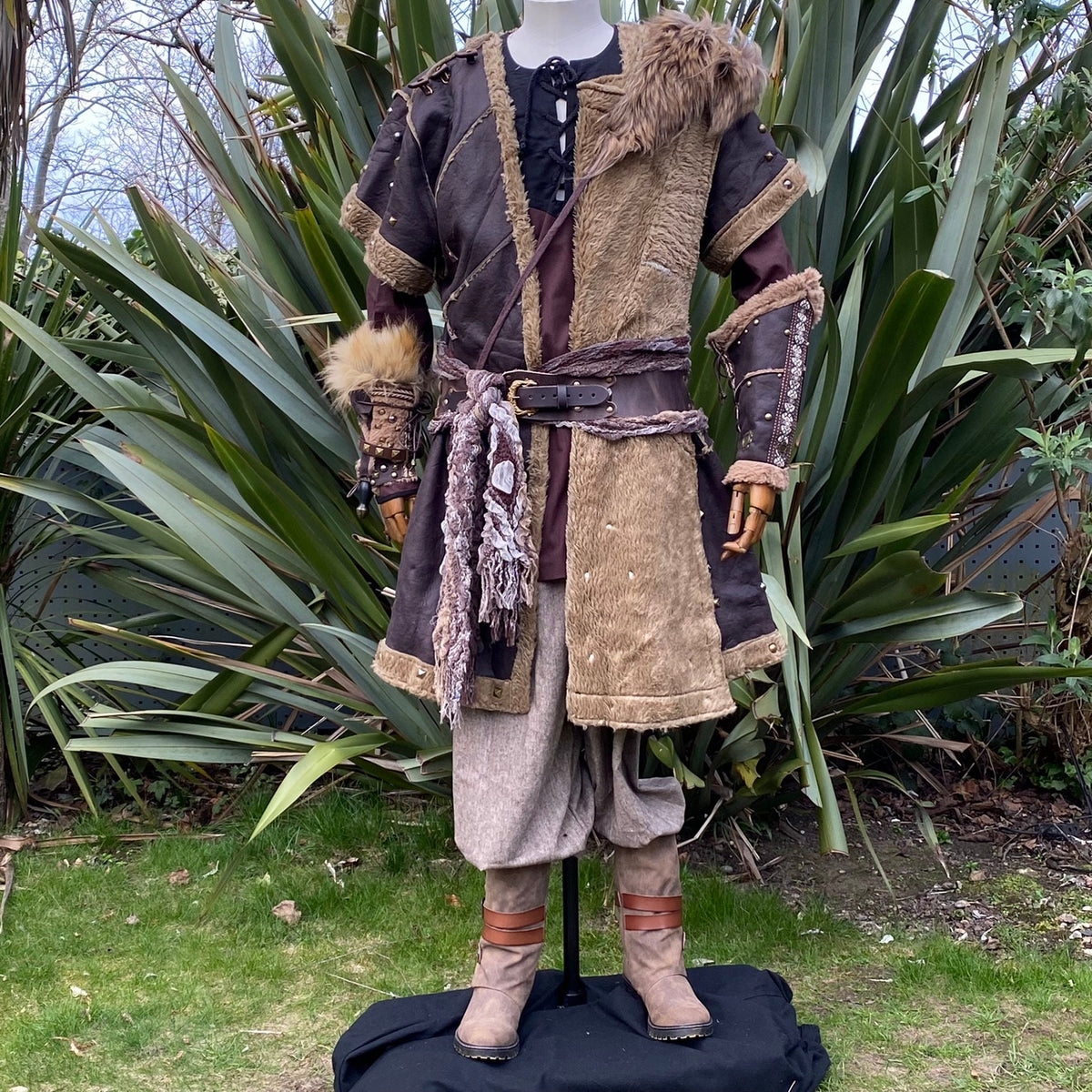 Mannequin in medieval Beast Master LARP outfit with fur hood and belt, front view.