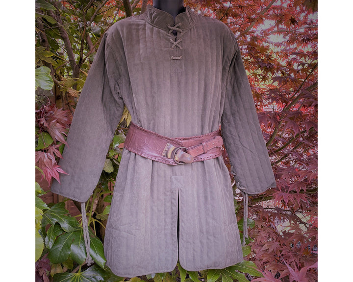 This Thin LARP Gambeson comes in Brown Cotton. This Padded Tunic can sit on top of the rest of your kit. This Lightweight Gambeson is water resistant and keeps you warm. This Viking Tunic is perfect for your LARP Costume and LARP Character, Cosplay Events, and Ren Faires.