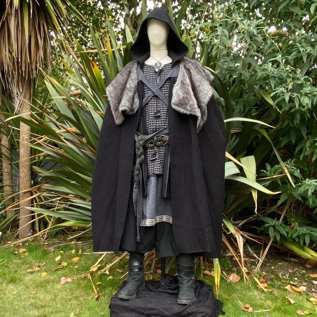 The Four Way LARP Cloak in Black Herringbone Wool with Reversable Grey Faux Fur & Leather Brown Mantle is a Versatile Cape with Hood. The Medieval Cloak is Water Resistant and helps keep you warm. The Viking Style Cloak can be worn in four ways; perfect for your LARP character, Cosplay Events, and Ren Faires. 