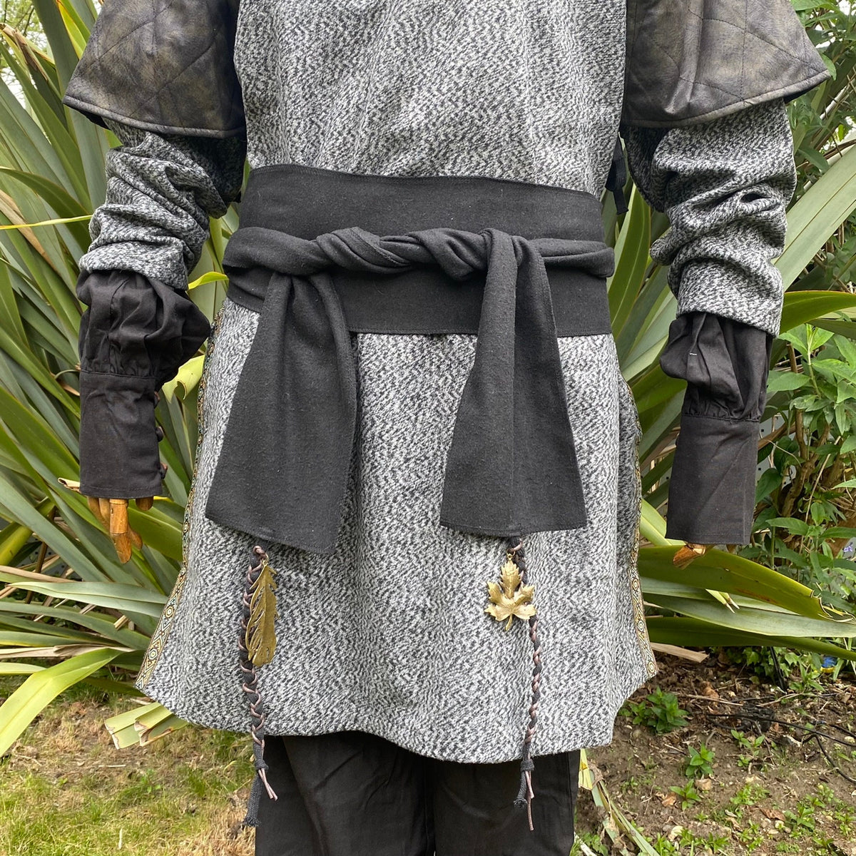 Medieval LARP black wool sash on grey tunic with leaf details.