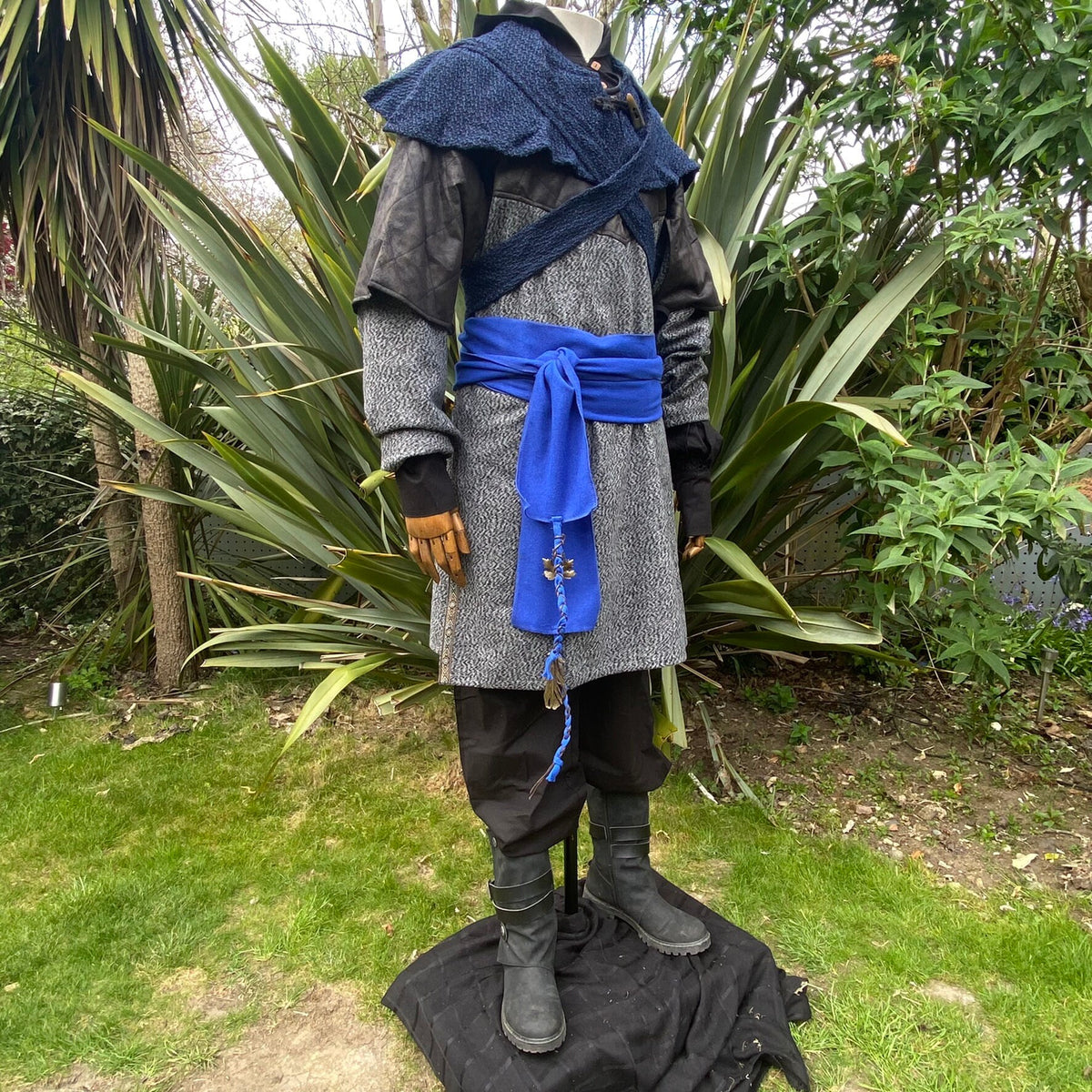 Medieval LARP outfit with blue wool sash draped over chainmail tunic.