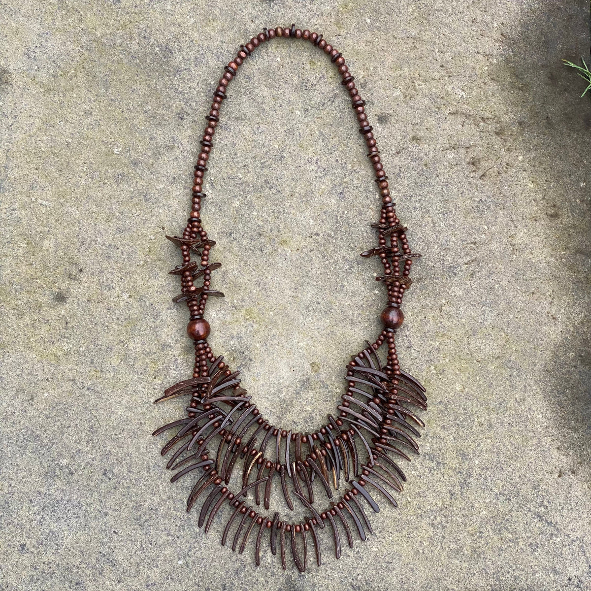 Triple layer brown tooth necklace on stone for LARP.