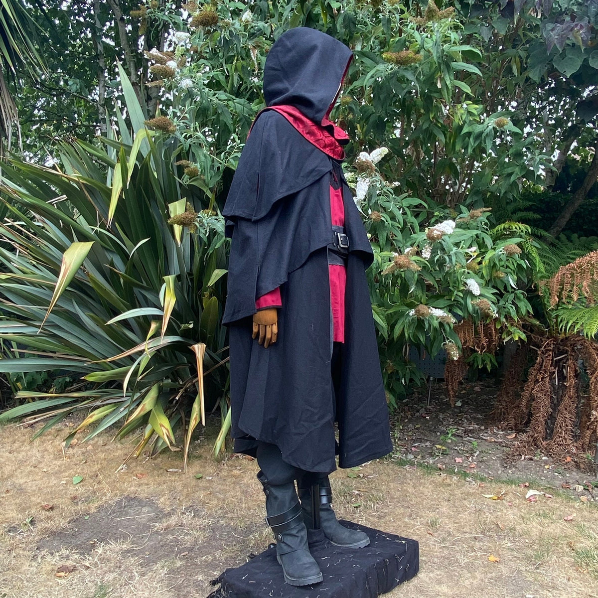 Medieval LARP costume side view featuring a 3-layered cloak, shirt, and belt.