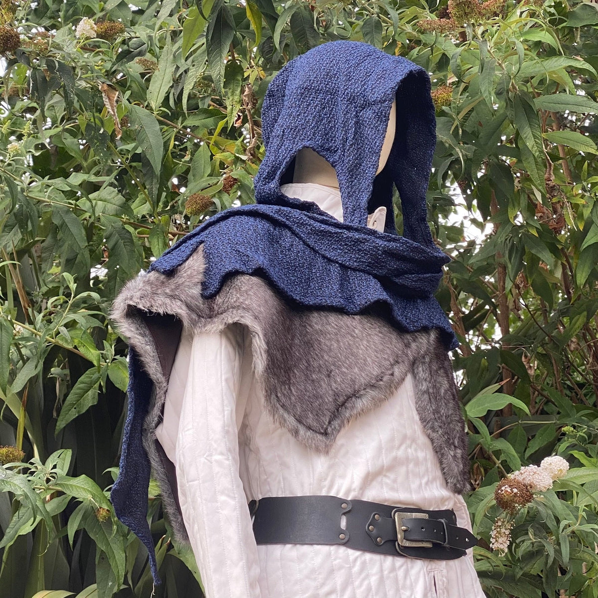 Druid LARP costume side view; blue hood, faux fur mantle.