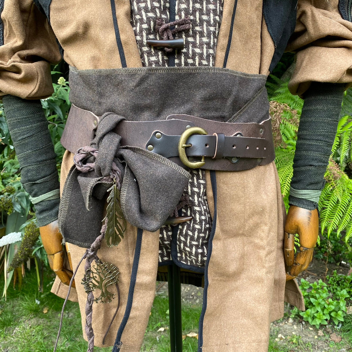Green herringbone medieval arm wraps with leather and fabric accents for LARP.