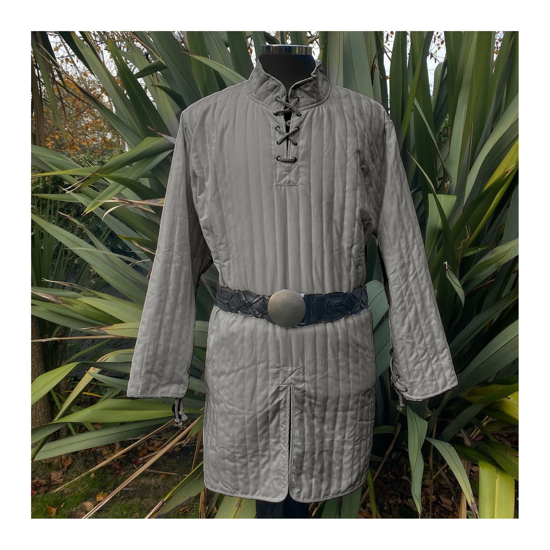 This Thin LARP Gambeson comes in Grey Cotton. This Padded Tunic can sit on top of the rest of your kit. This Lightweight Gambeson is water resistant and keeps you warm. This Viking Tunic is perfect for your LARP Costume and LARP Character, Cosplay Events, and Ren Faires.