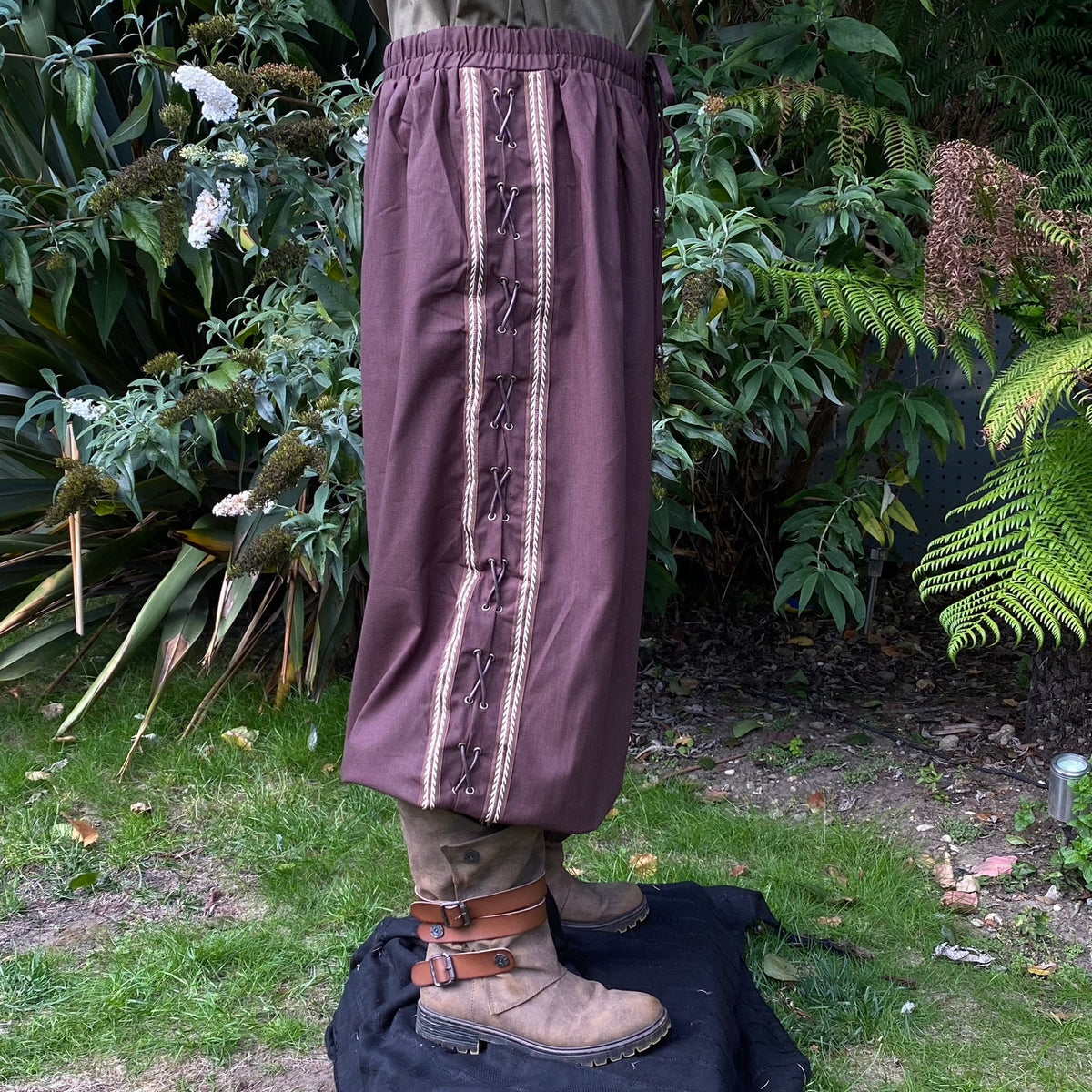 Side view of brown LARP trousers with lace detail.